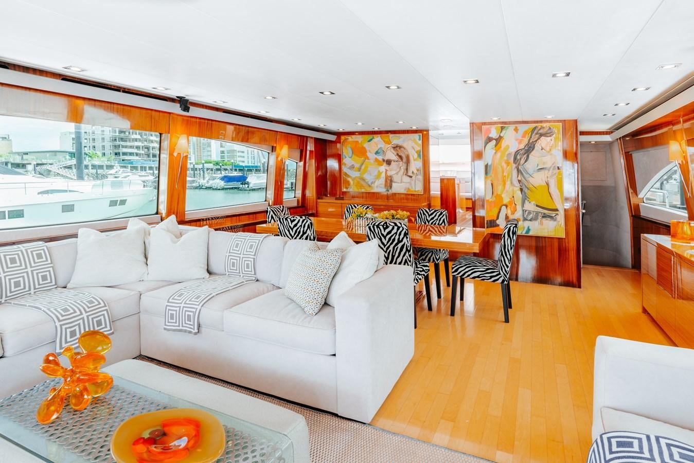 a living room with a large window aboard HATTERAS 105 Yacht for Sale