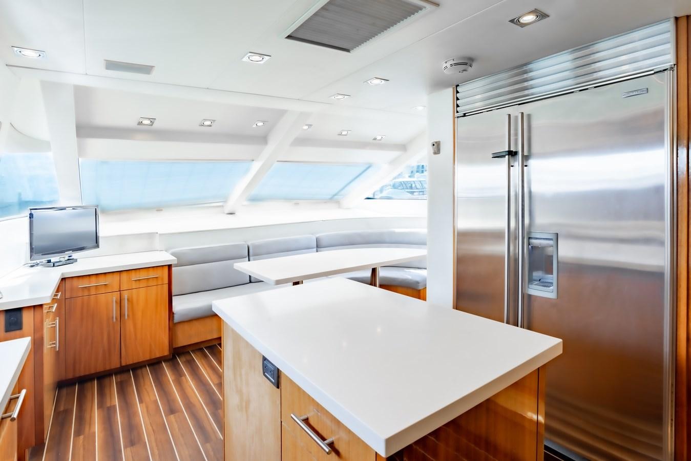 a large kitchen with a large refrigerator aboard HATTERAS 105 Yacht for Sale