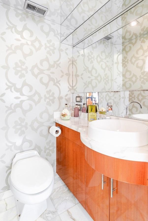 a bathroom with a toilet and sink aboard HATTERAS 105 Yacht for Sale
