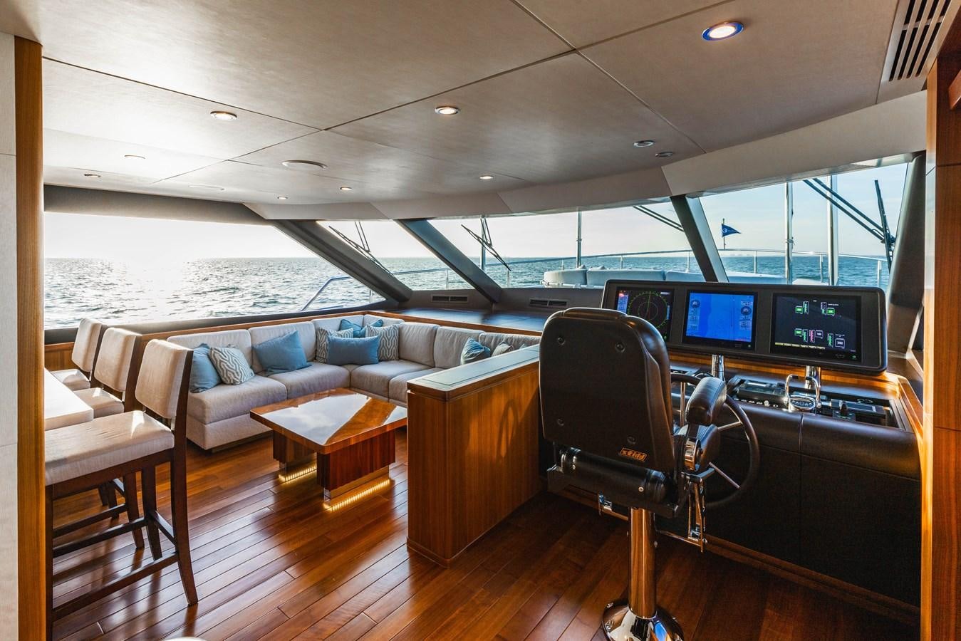 a room with a couch and a table with chairs and a television aboard SEE WORTHY Yacht for Sale