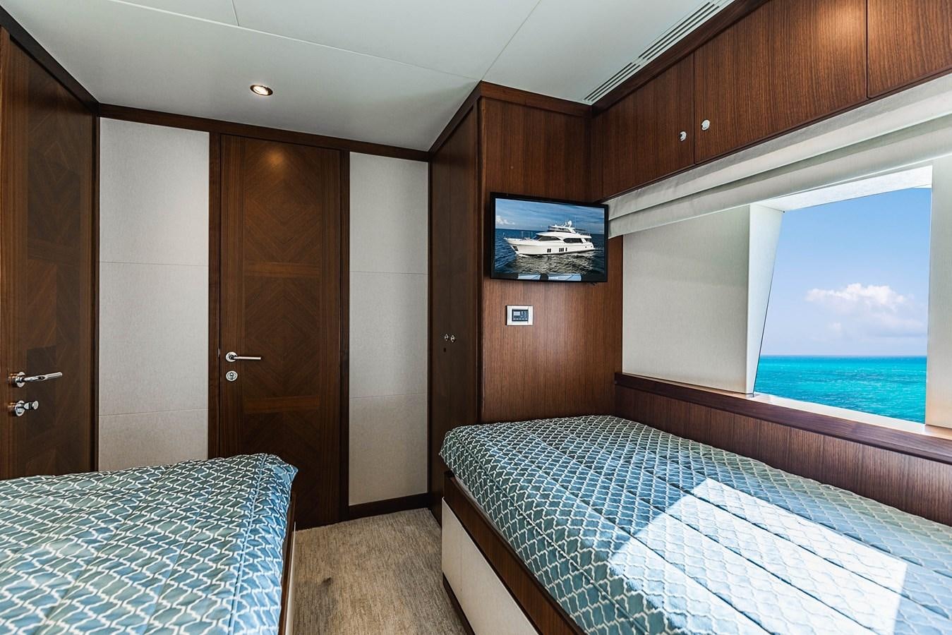 a room with a bed and a television on the wall aboard SEE WORTHY Yacht for Sale