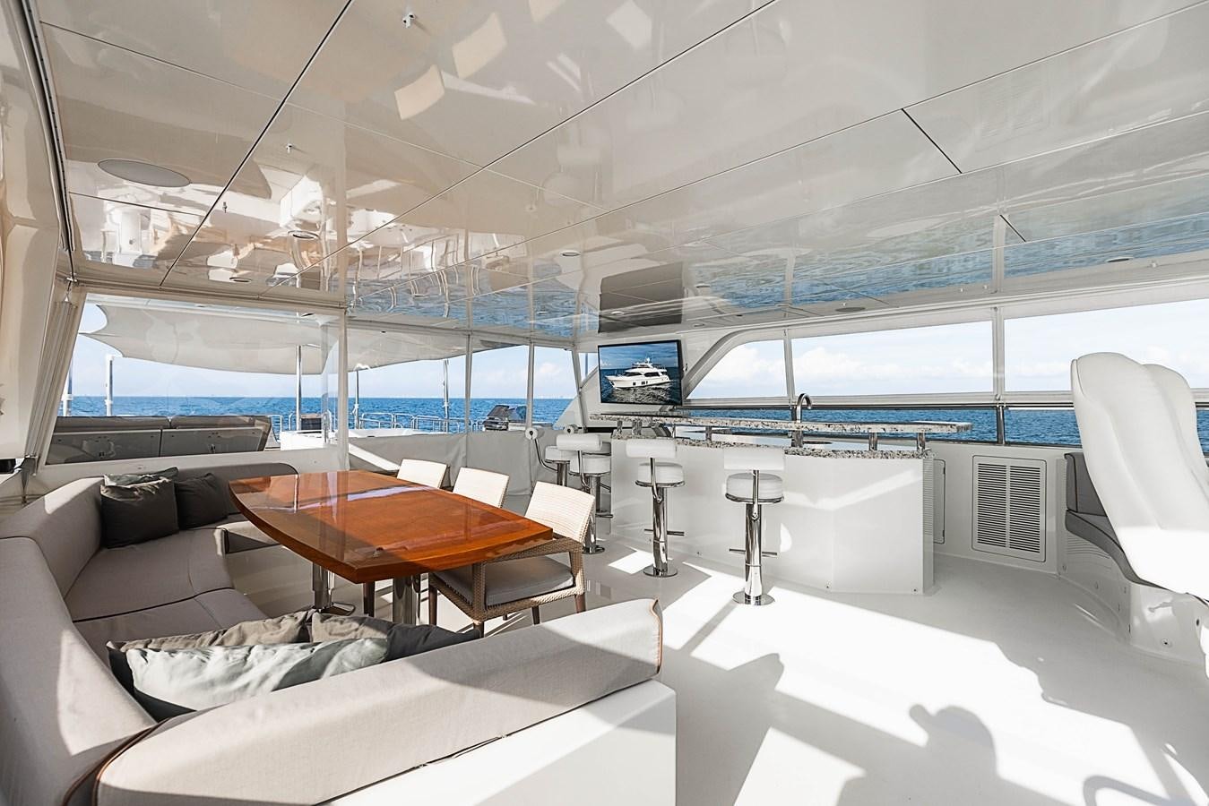 inside of a building with a large window and a table and chairs aboard SEE WORTHY Yacht for Sale