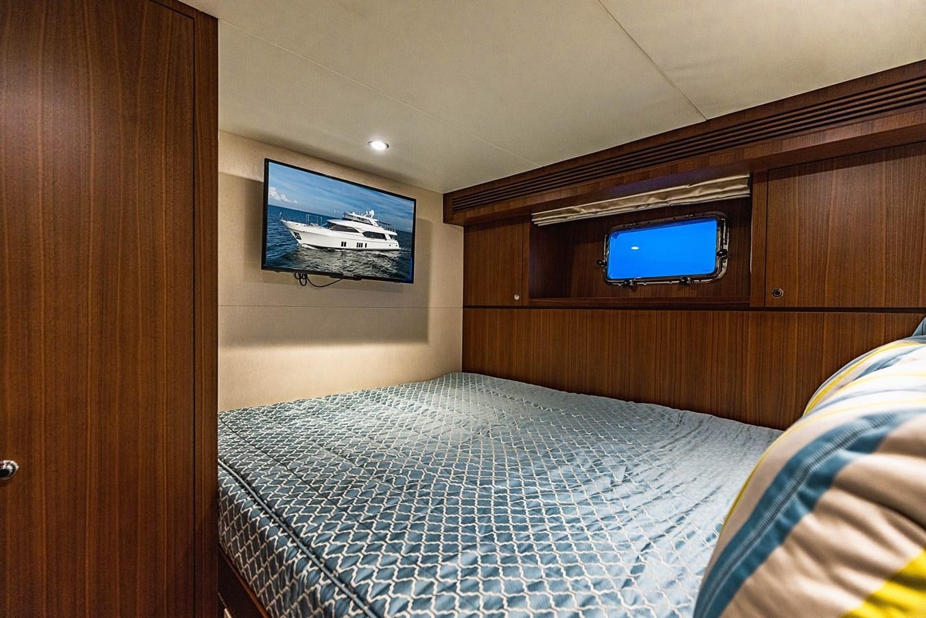 a bed with a television on the wall aboard SEE WORTHY Yacht for Sale