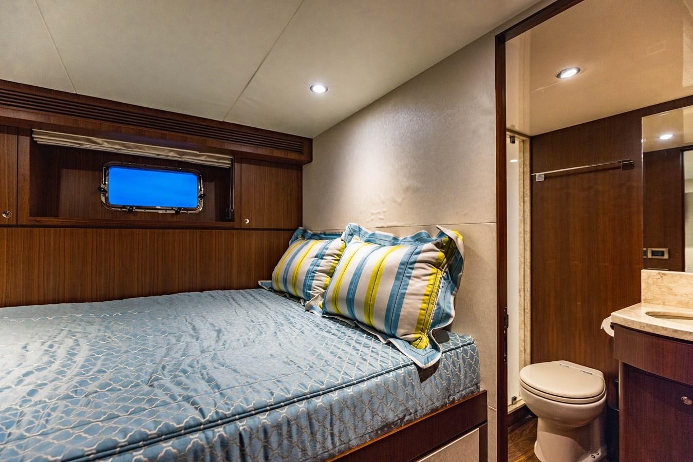 a bedroom with a bed and a television aboard SEE WORTHY Yacht for Sale