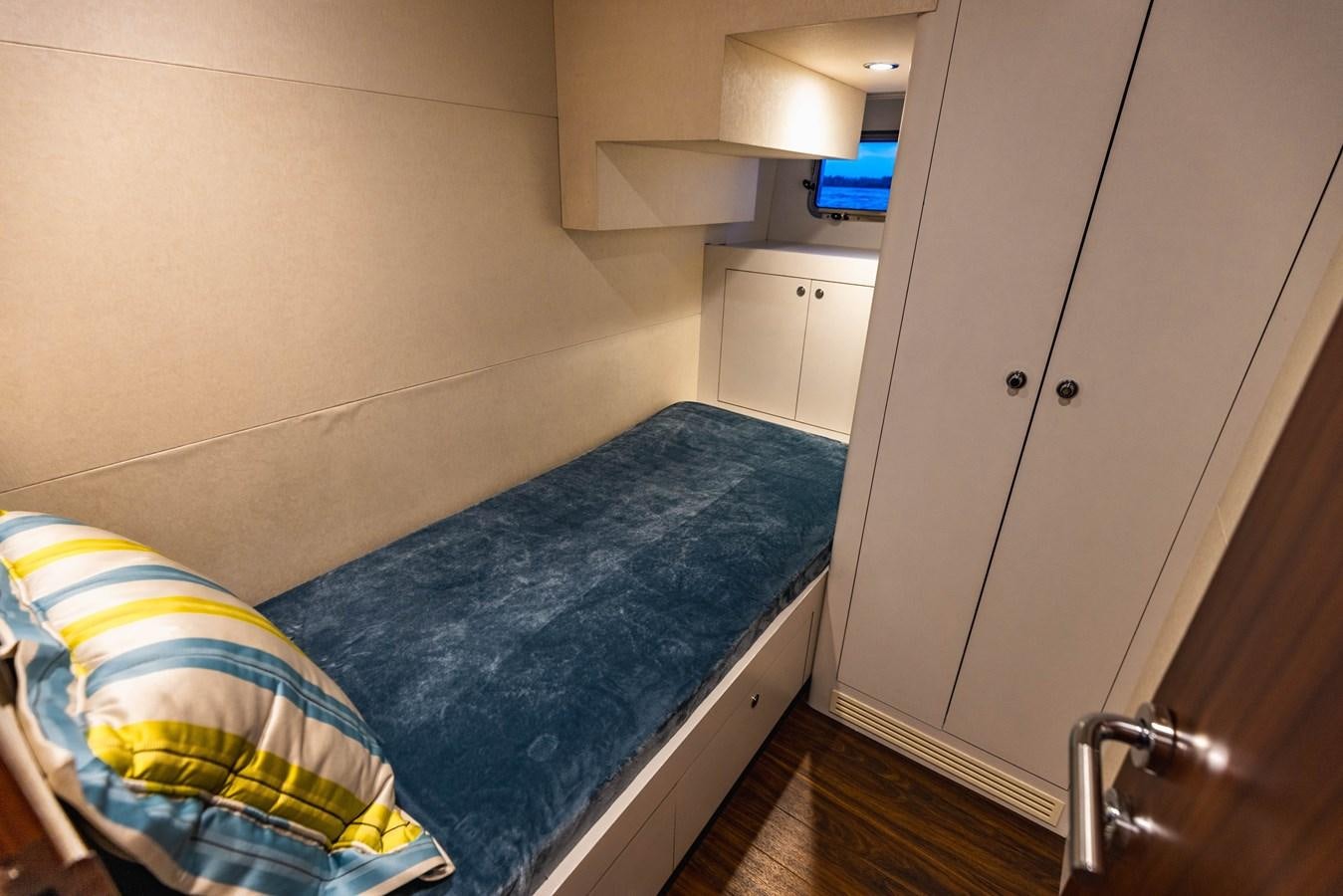 a bedroom with a bed and a desk aboard SEE WORTHY Yacht for Sale