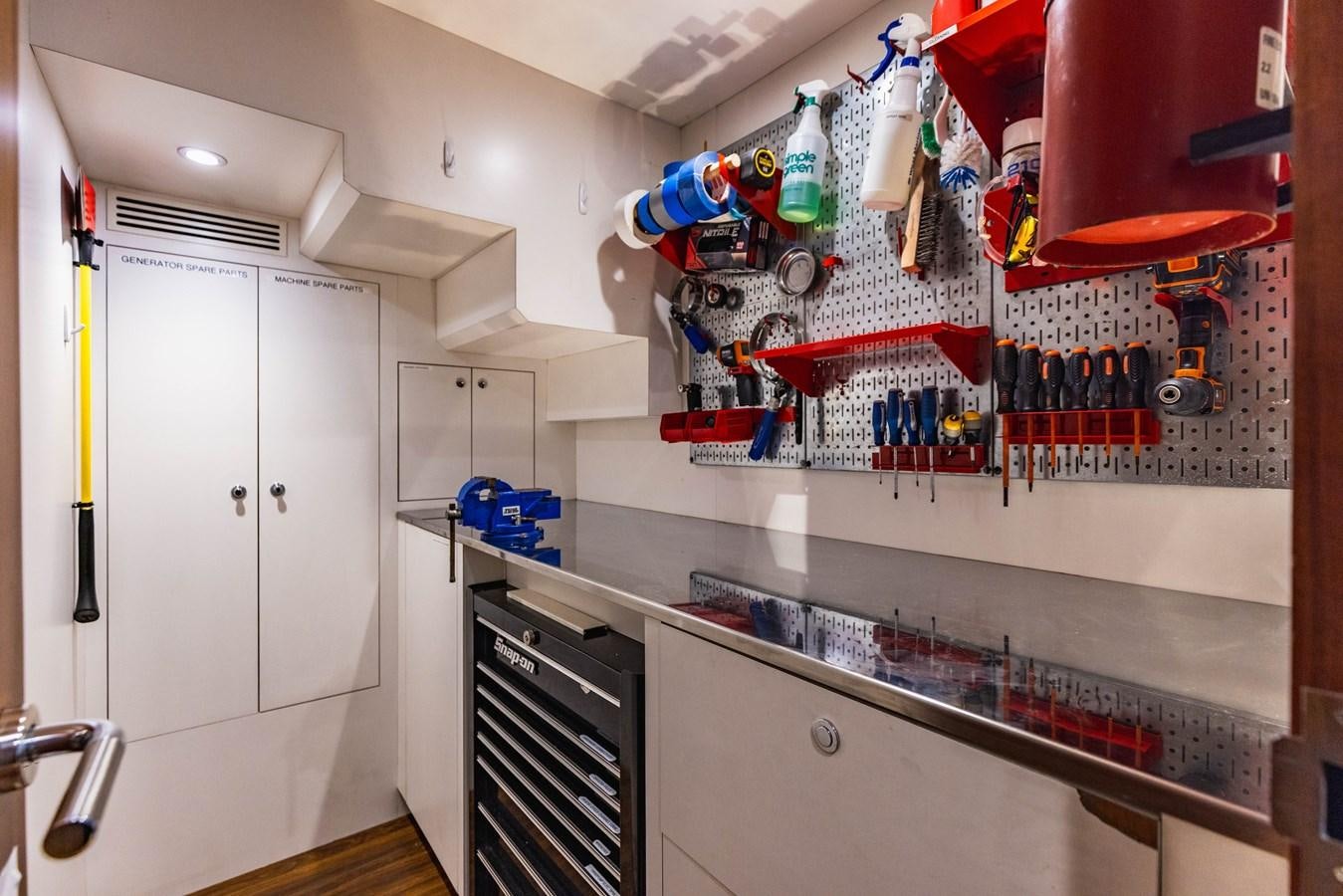 a room with a shelf and a shelf with bottles and a shelf with objects on it aboard SEE WORTHY Yacht for Sale