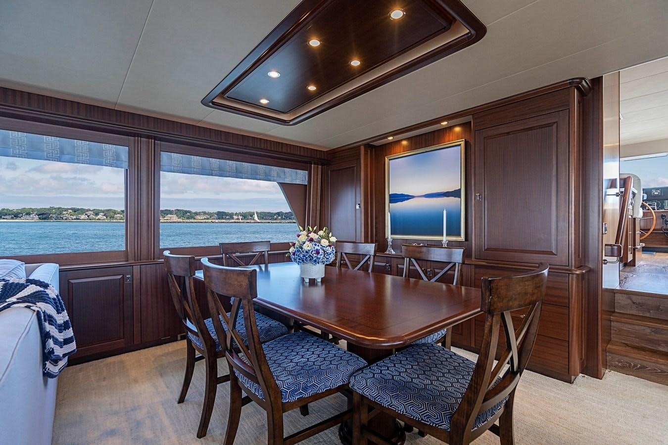 a dining room with a large window aboard TRANQUILITY Yacht for Sale