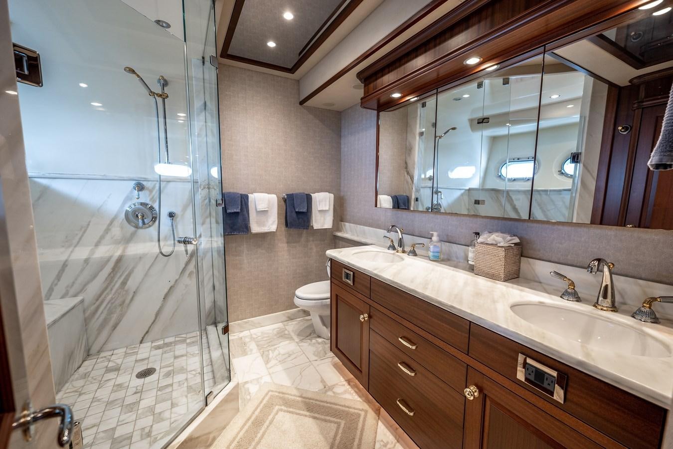 a bathroom with a glass shower aboard TRANQUILITY Yacht for Sale