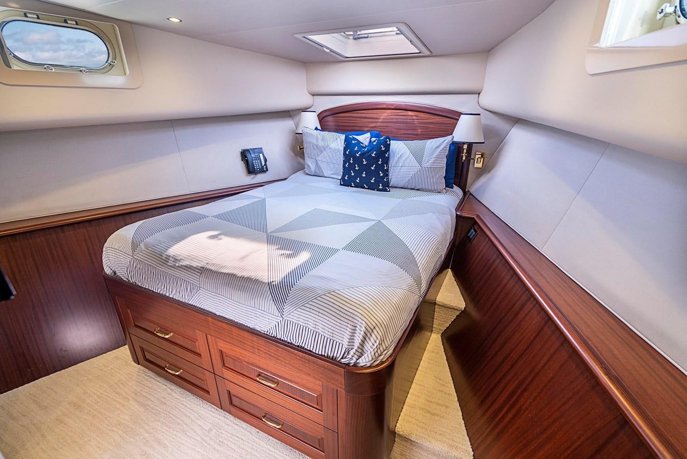 a bed with a blue cover aboard TRANQUILITY Yacht for Sale