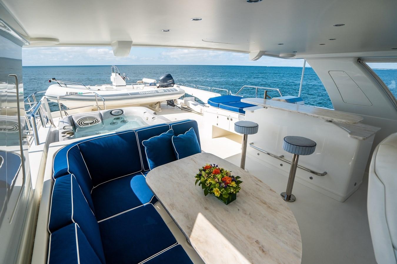 a room with a table chairs and flowers on the table aboard TRANQUILITY Yacht for Sale