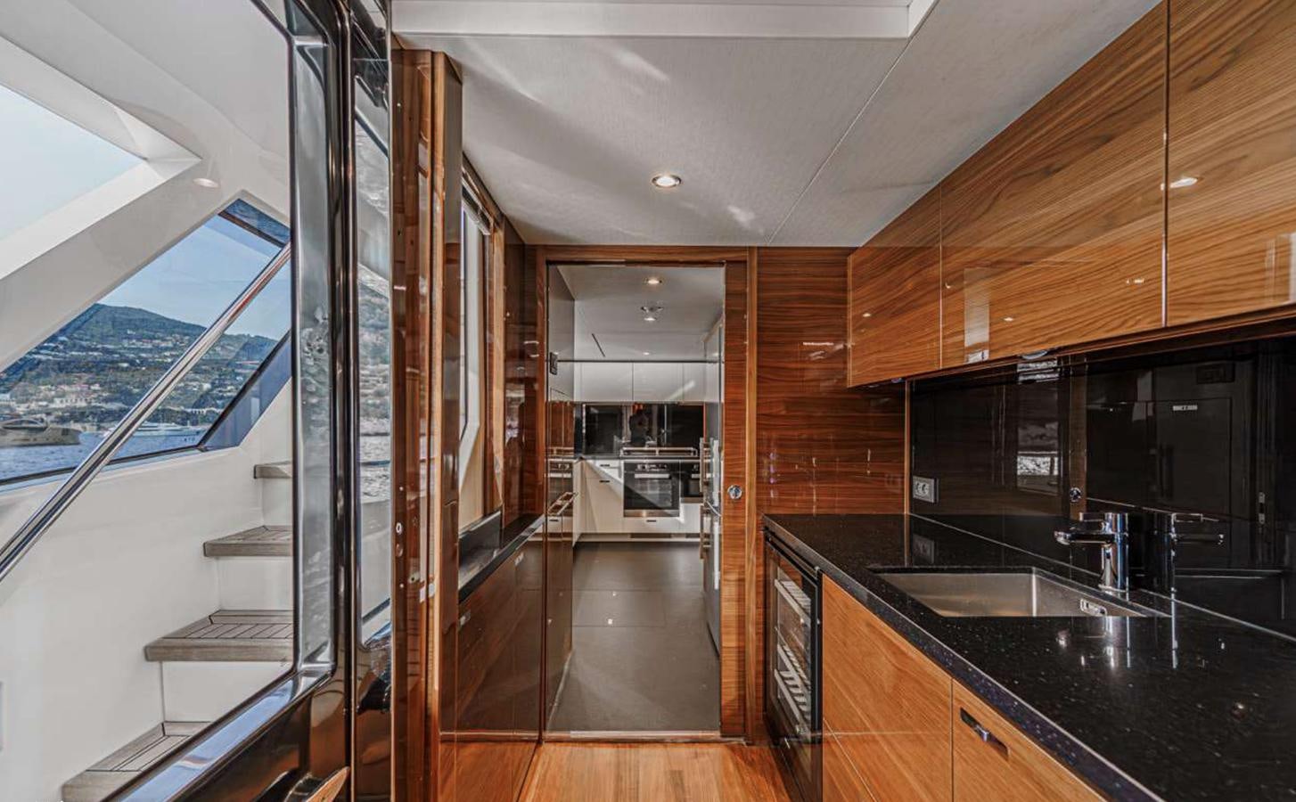 a kitchen with a large glass door aboard PRINCESS 35M AVALON Yacht for Sale