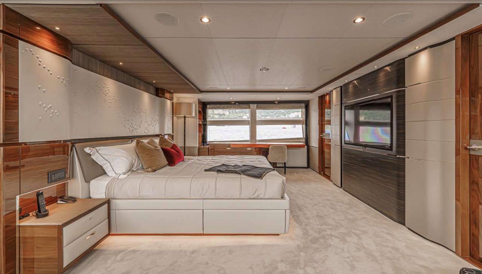 a bedroom with a bed and a tv aboard PRINCESS 35M AVALON Yacht for Sale