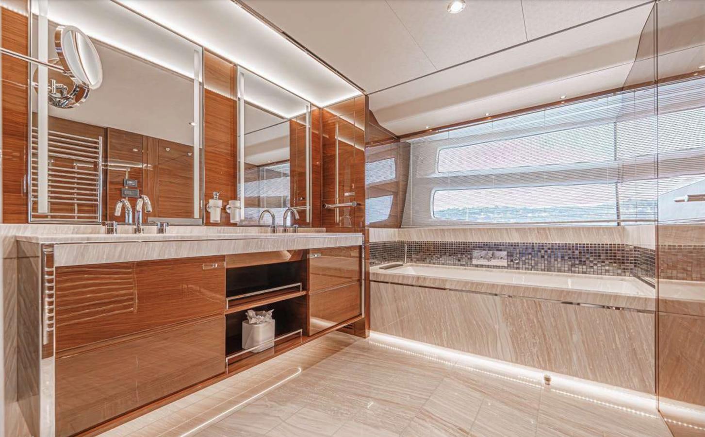 a large bathroom with wooden cabinets aboard PRINCESS 35M AVALON Yacht for Sale