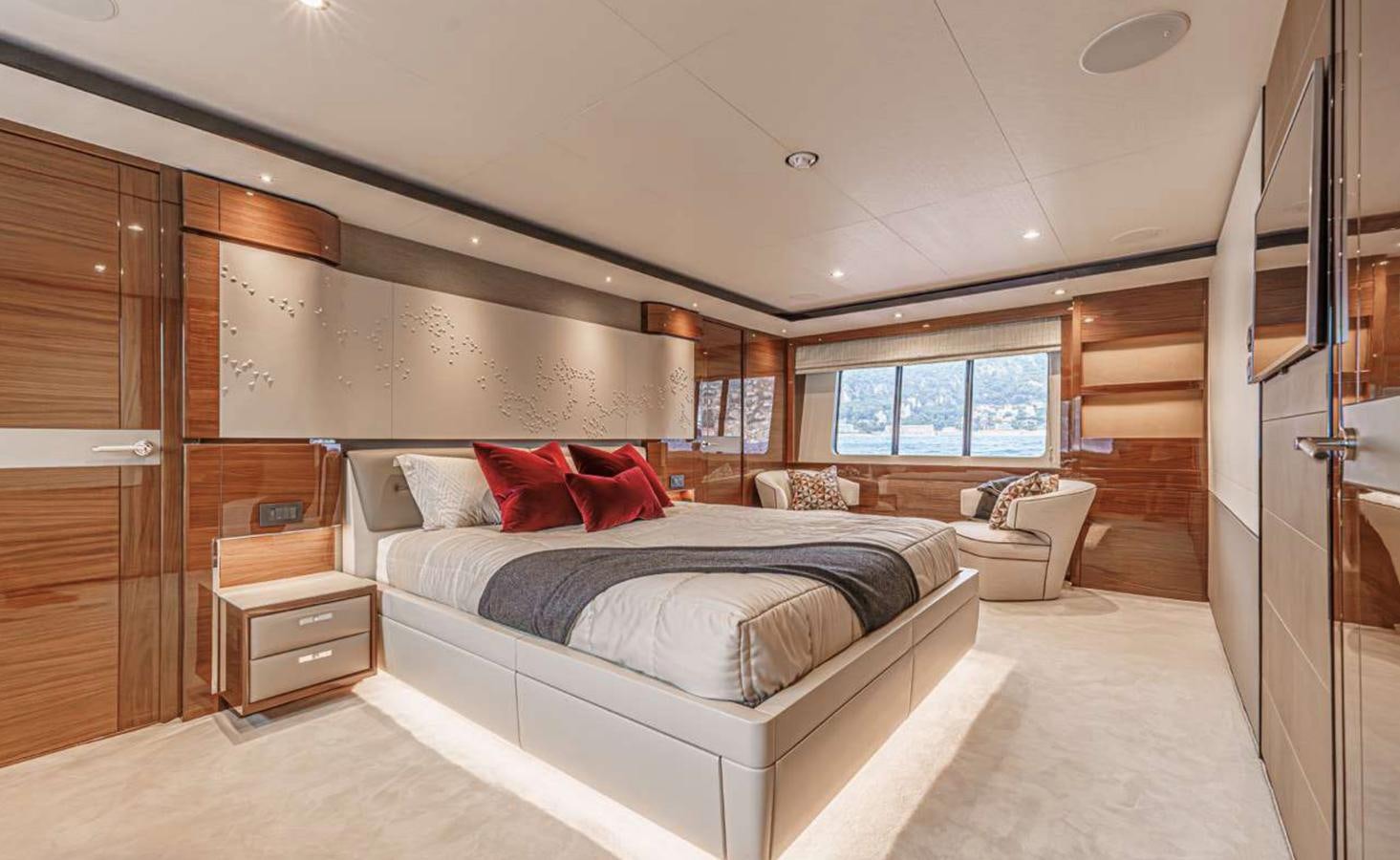 a bedroom with a bed and a dresser aboard PRINCESS 35M AVALON Yacht for Sale
