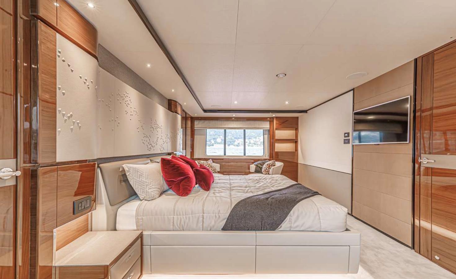 a bedroom with a bed and a window aboard PRINCESS 35M AVALON Yacht for Sale