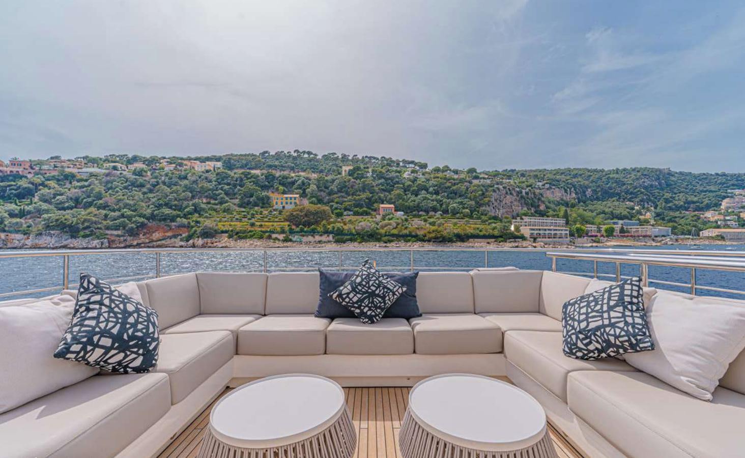 a couch and a table on a balcony overlooking a city aboard PRINCESS 35M AVALON Yacht for Sale