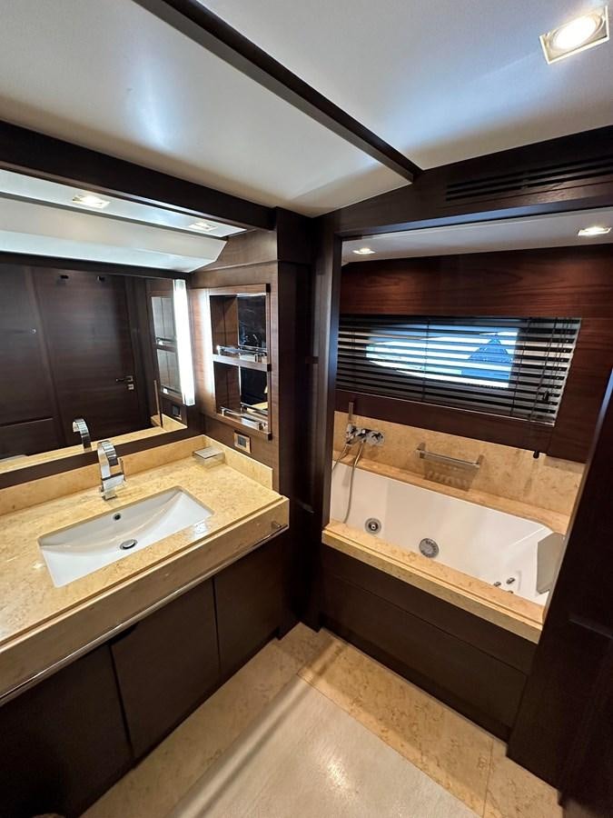 a bathroom with a tub sink and a large window aboard AZIMUT GRANDE 116 Yacht for Sale