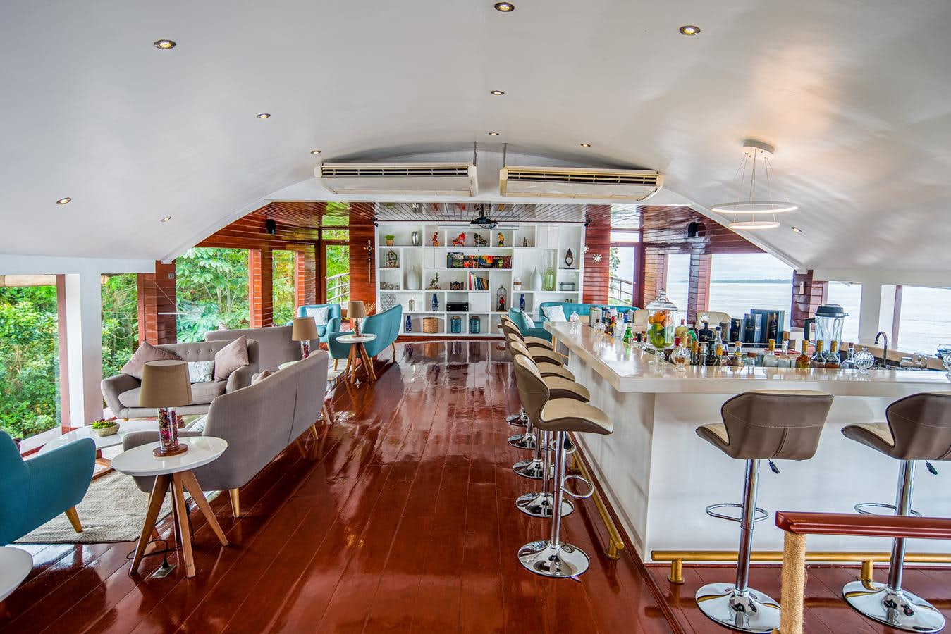 a room with tables and chairs aboard CRUCERO AMAZONAS Yacht for Sale