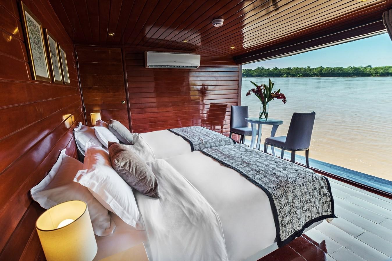 a person lying in a bed aboard CRUCERO AMAZONAS Yacht for Sale