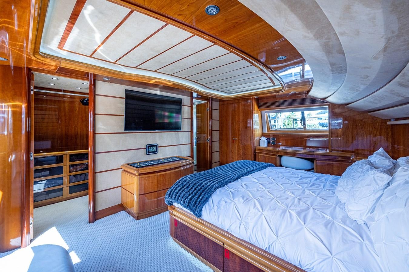 a room with a bed and a television aboard EVERYTHING GOOD Yacht for Sale