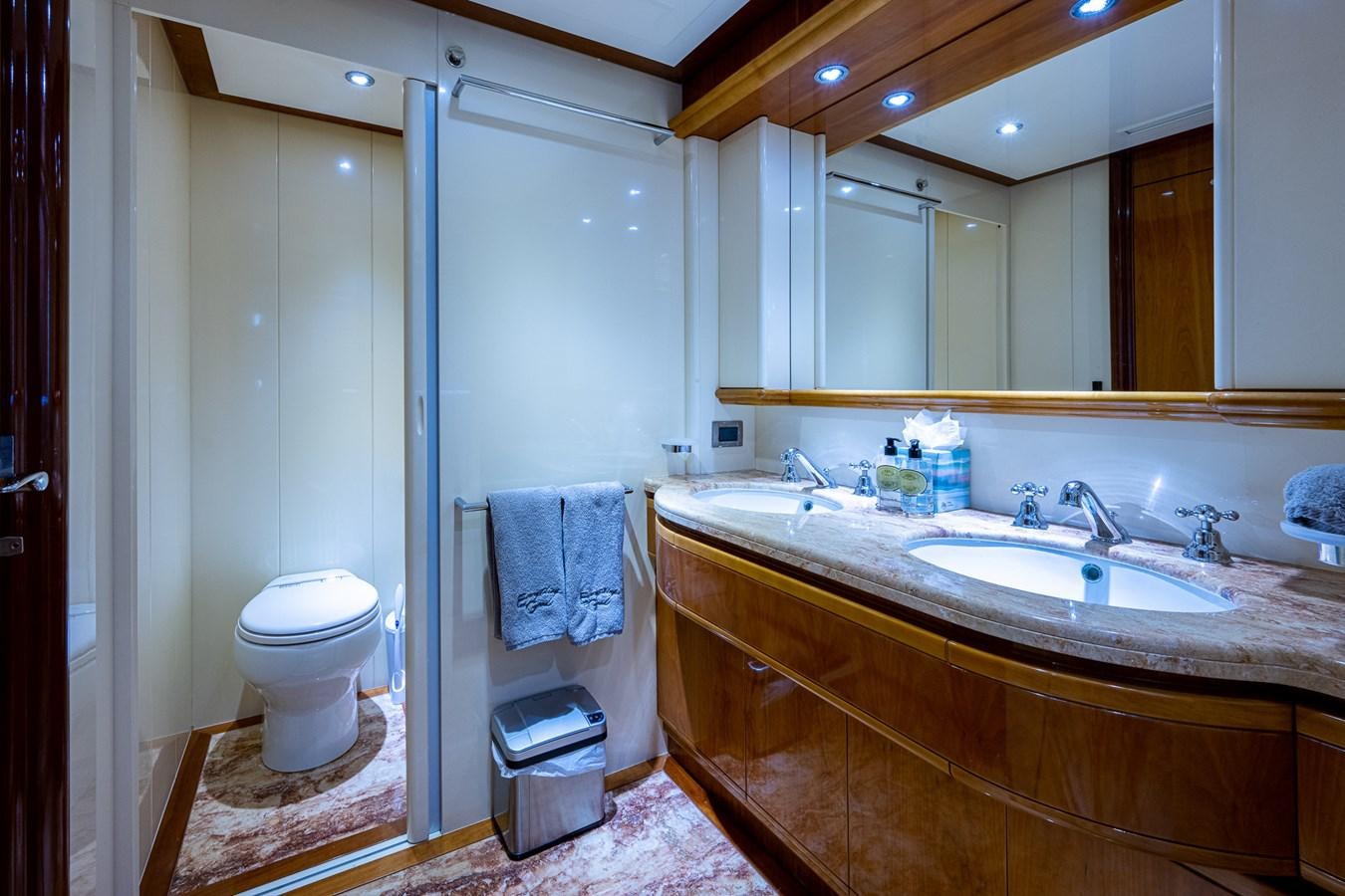 a bathroom with a sink toilet and a mirror aboard EVERYTHING GOOD Yacht for Sale