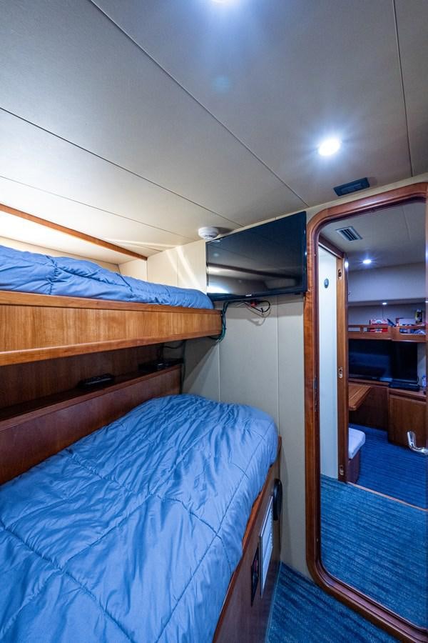 a room with a bed and a mirror aboard EVERYTHING GOOD Yacht for Sale