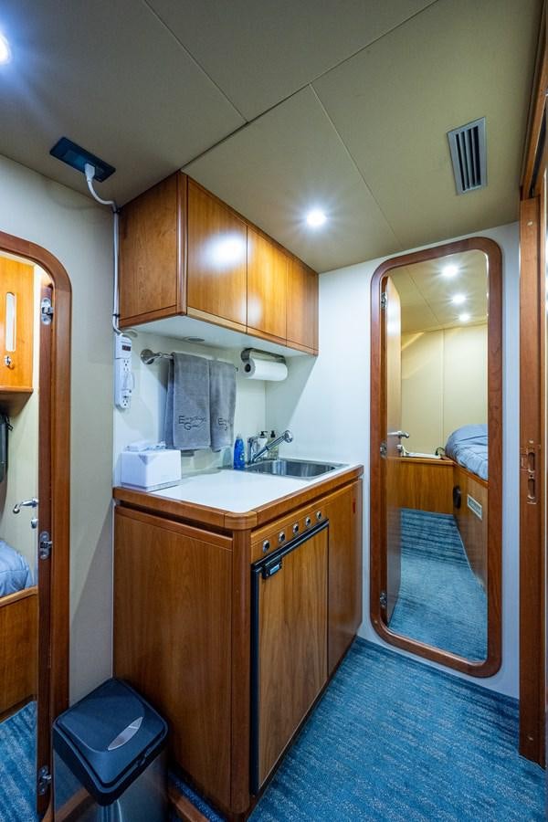 a bathroom with wooden cabinets aboard EVERYTHING GOOD Yacht for Sale