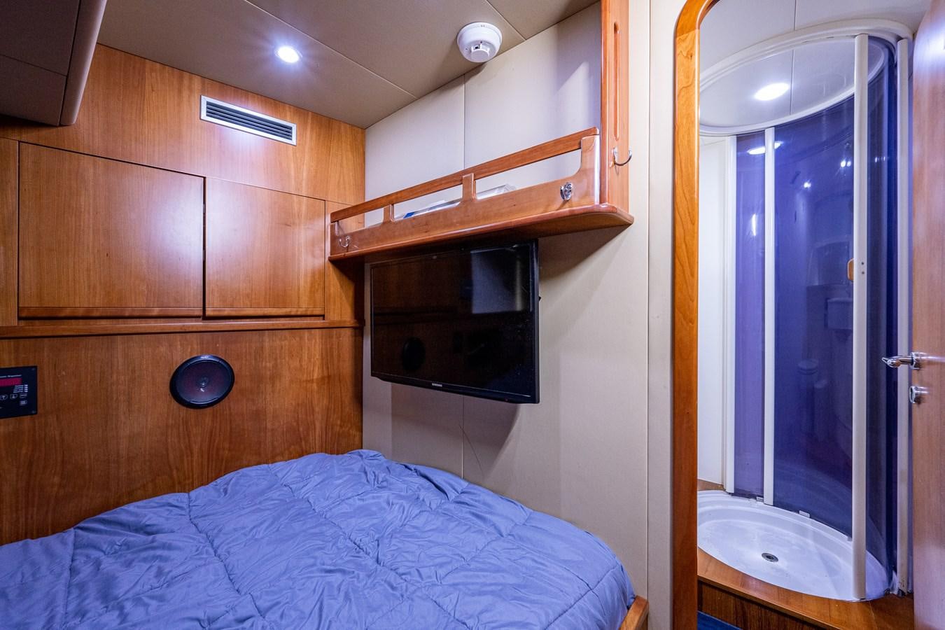 a bedroom with a bed and a television aboard EVERYTHING GOOD Yacht for Sale