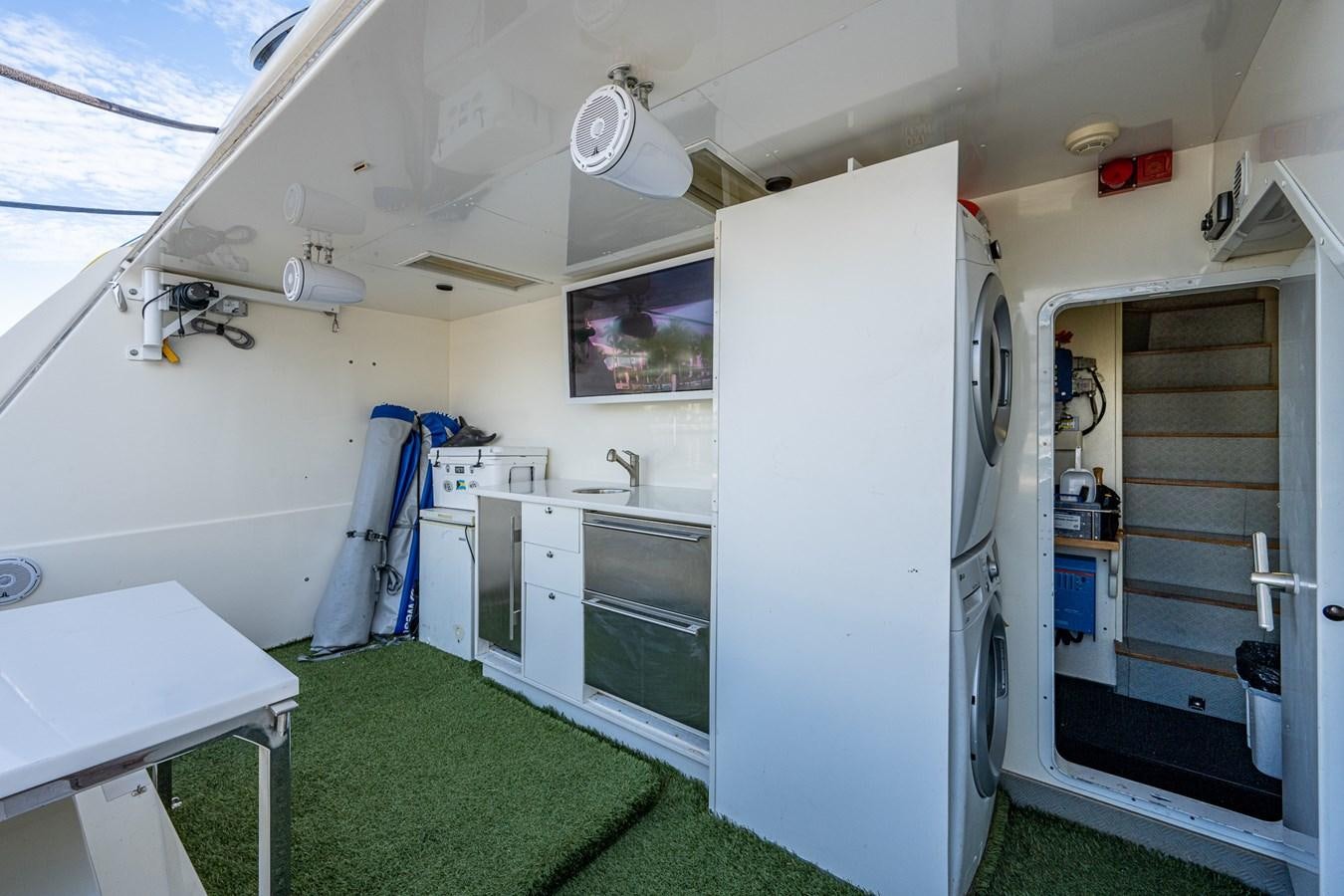 a small kitchen with a refrigerator aboard EVERYTHING GOOD Yacht for Sale