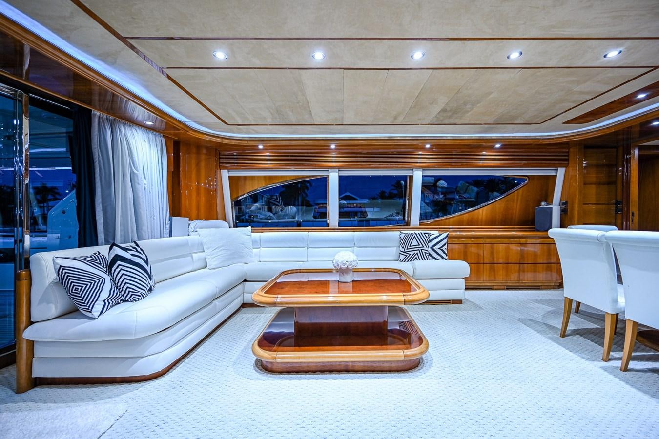 a large living room with a large white couch and a large table aboard EVERYTHING GOOD Yacht for Sale