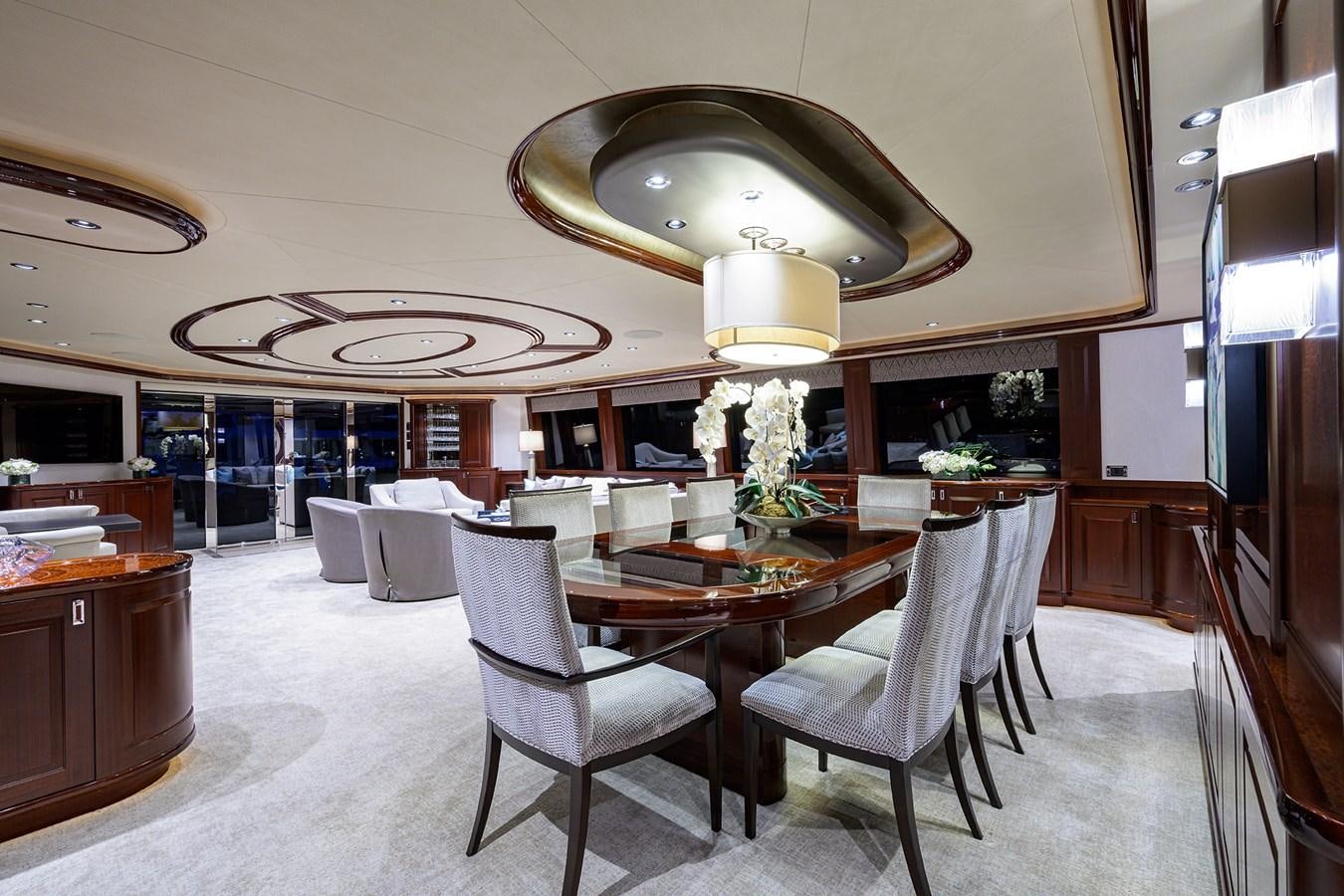 a large room with a table and chairs aboard TIRELESS Yacht for Sale