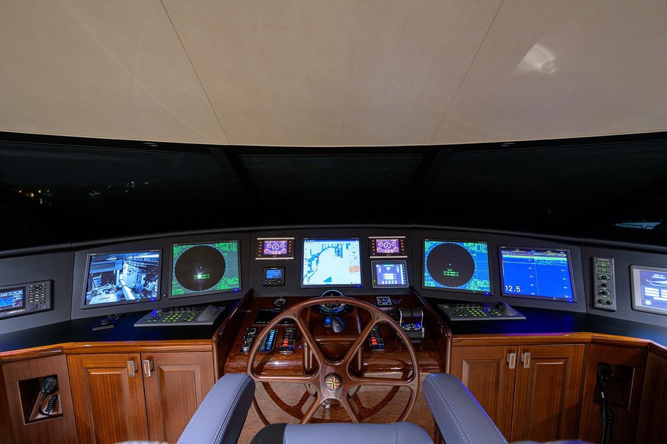 a room with many monitors and a bicycle aboard TIRELESS Yacht for Sale