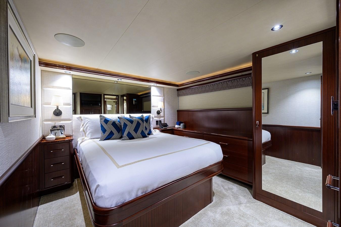 a bedroom with a bed and a mirror aboard TIRELESS Yacht for Sale
