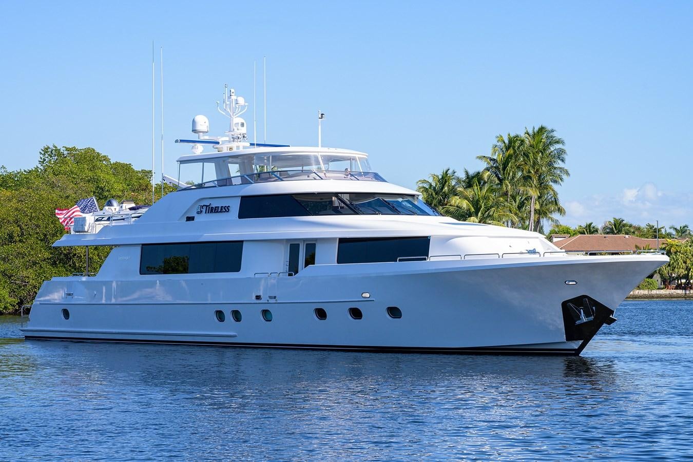 a white yacht on the water aboard TIRELESS Yacht for Sale