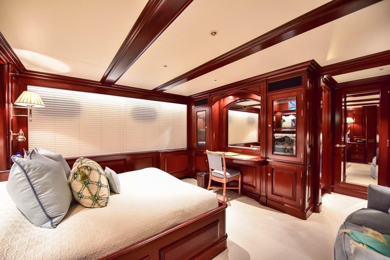 a bedroom with a bed and a chair aboard BERILDA Yacht for Sale