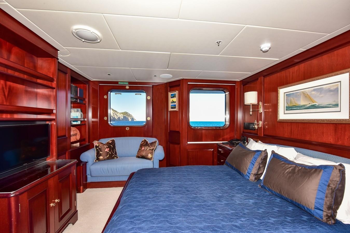 a bedroom with a bed and a television aboard BERILDA Yacht for Sale