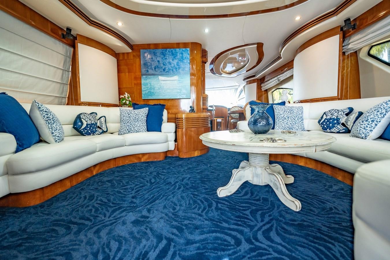 a large bedroom with a blue rug aboard GET WET Yacht for Sale