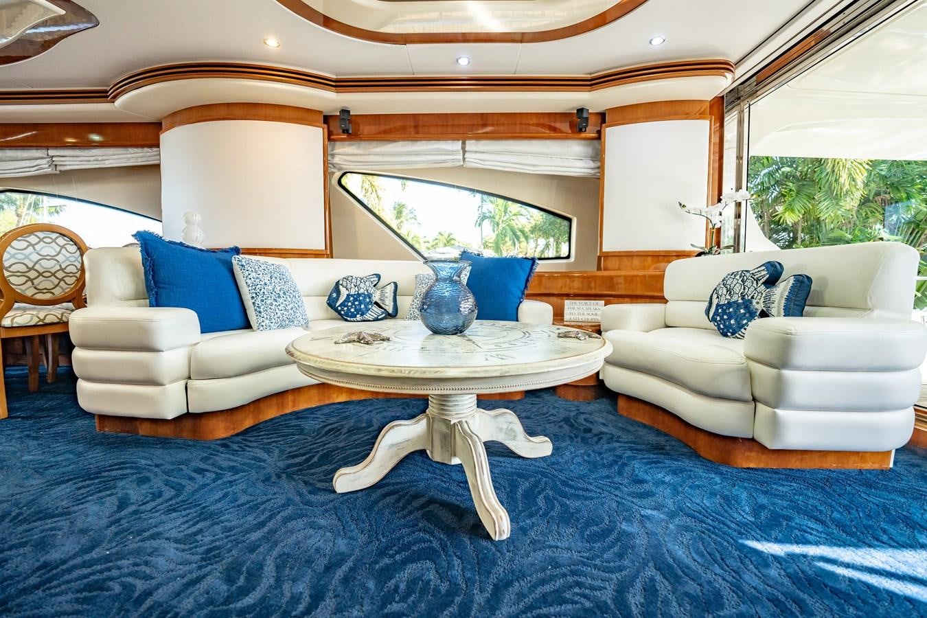 a living room with a blue rug aboard GET WET Yacht for Sale