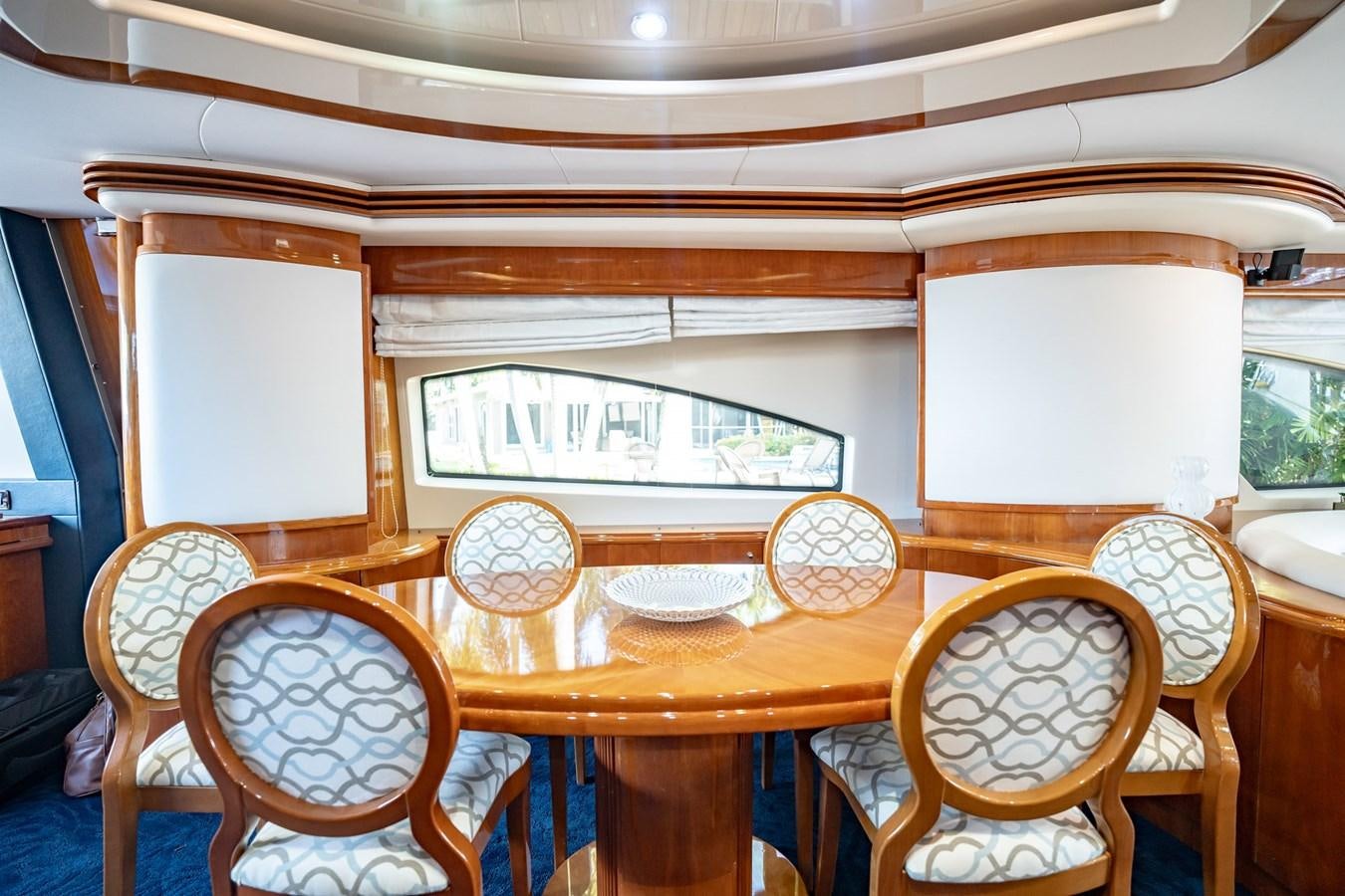 a small wooden table with chairs aboard GET WET Yacht for Sale