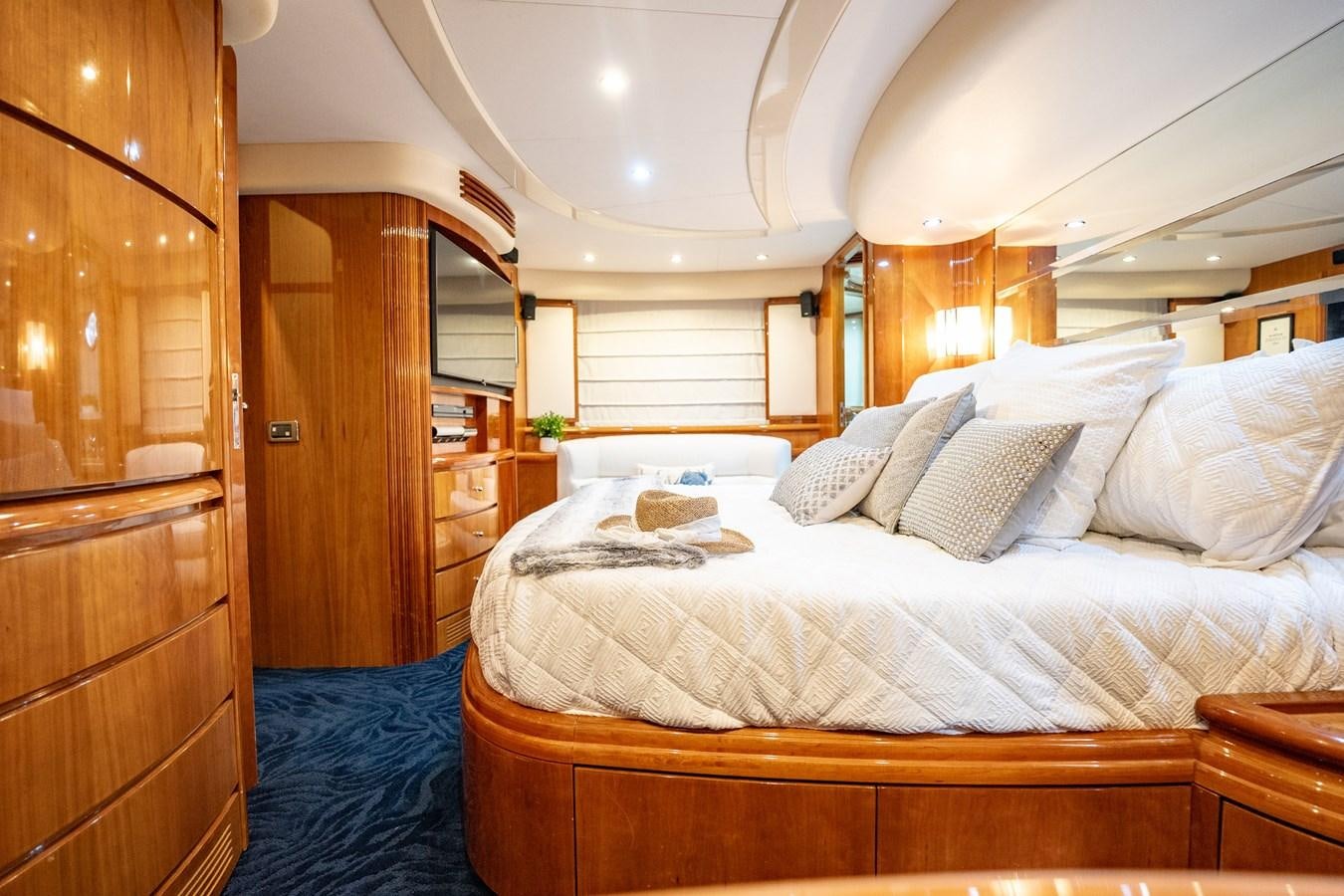 a bedroom with a bed and a wood door aboard GET WET Yacht for Sale