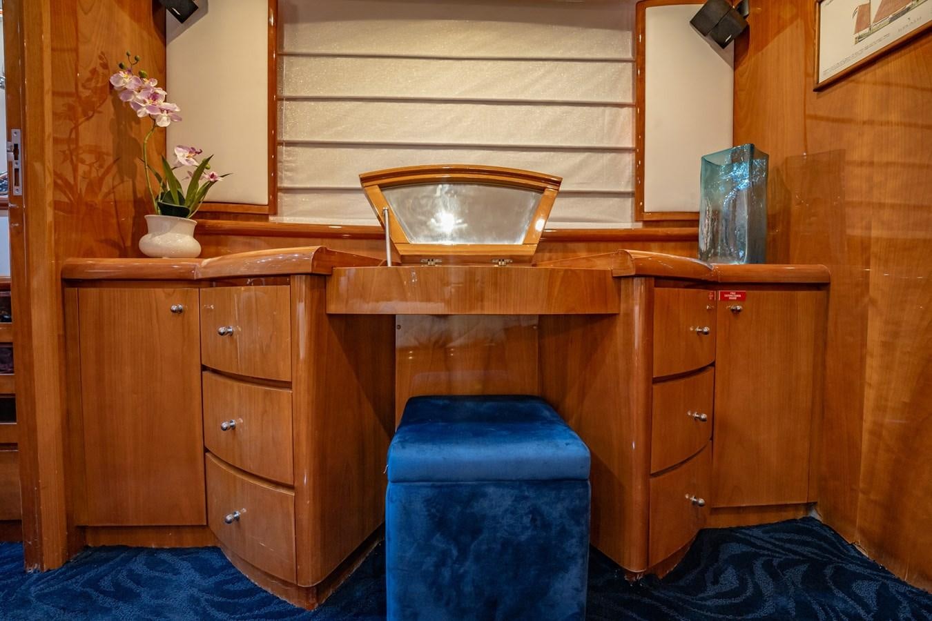 a wooden cabinet with a mirror above it aboard GET WET Yacht for Sale