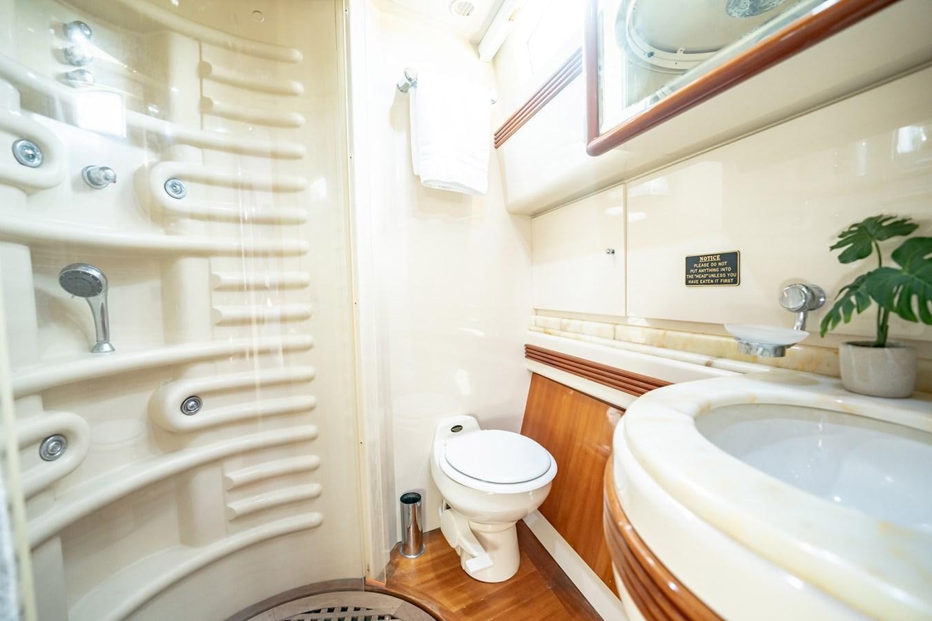 a bathroom with a toilet and sink aboard GET WET Yacht for Sale