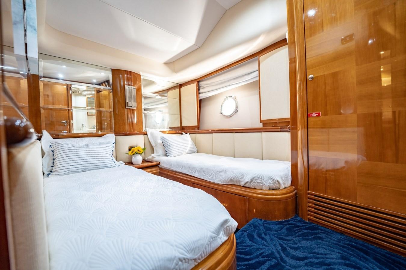 a room with two beds aboard GET WET Yacht for Sale