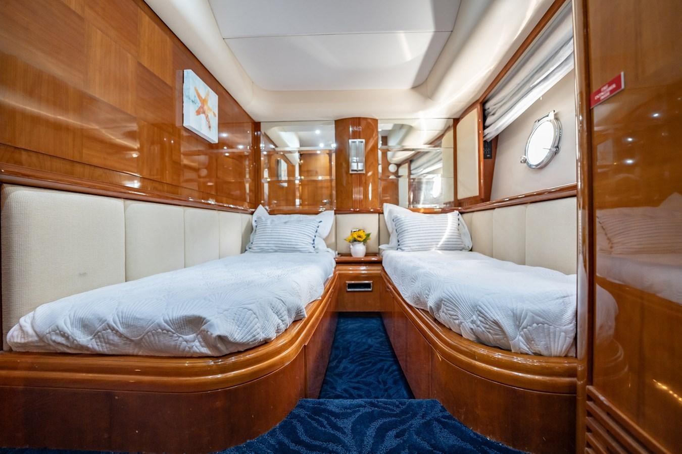 a room with two beds aboard GET WET Yacht for Sale