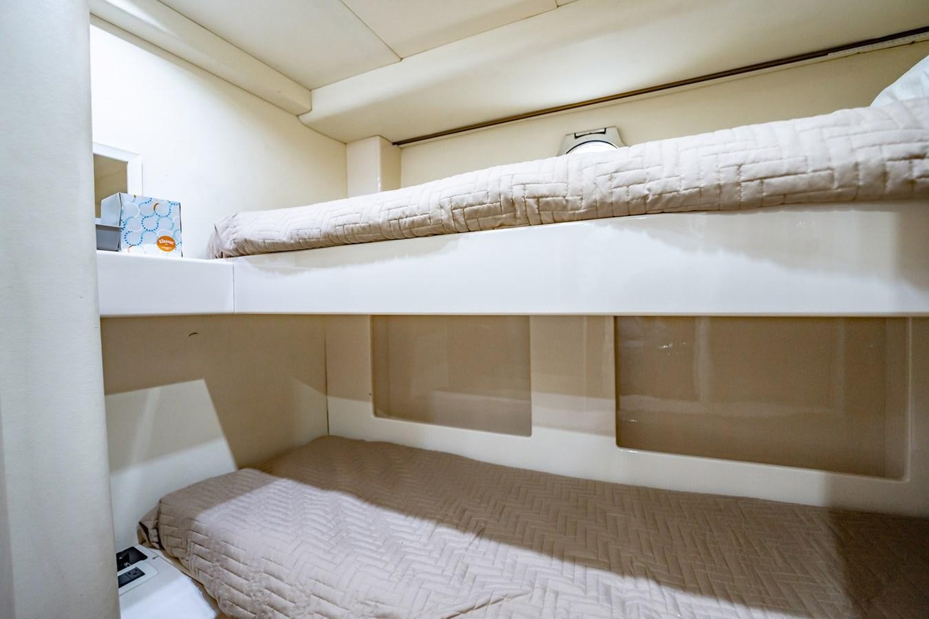 a white bed with a white sheet aboard GET WET Yacht for Sale
