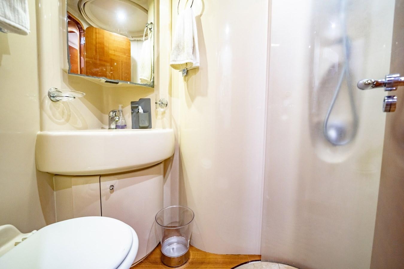 a bathroom with a sink toilet and shower aboard GET WET Yacht for Sale