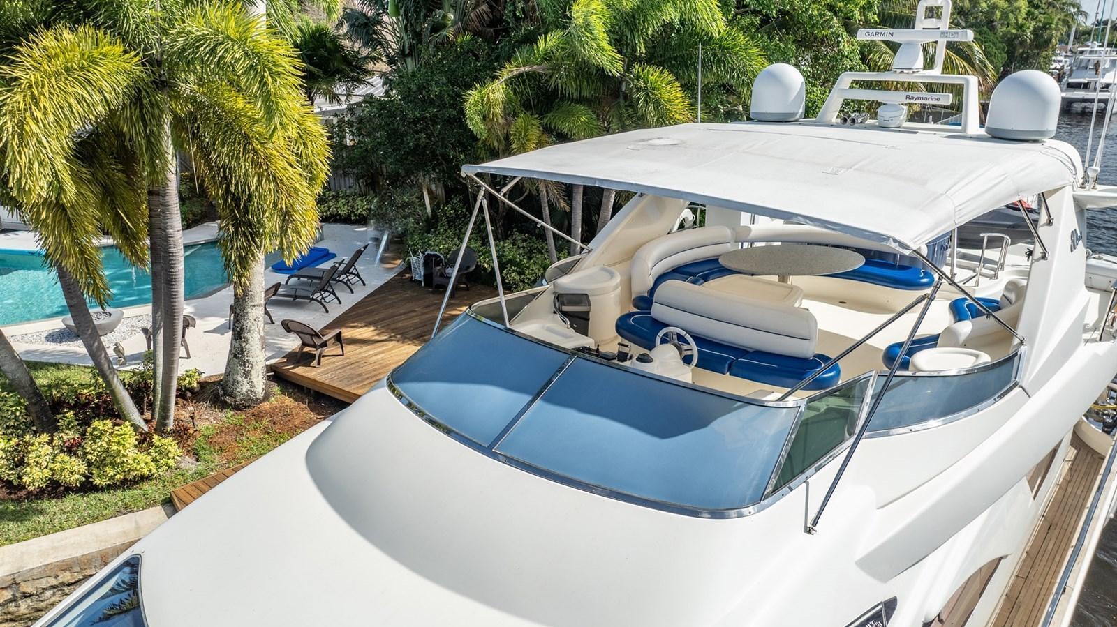 a white boat on a dock aboard GET WET Yacht for Sale
