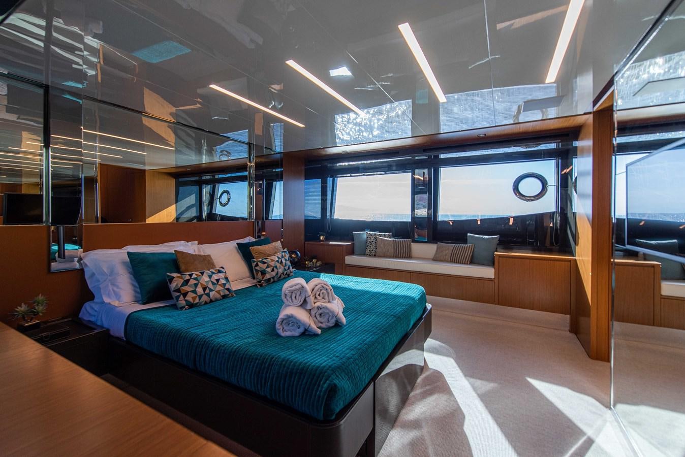 a room with a bed and a couch aboard SOUL Yacht for Sale