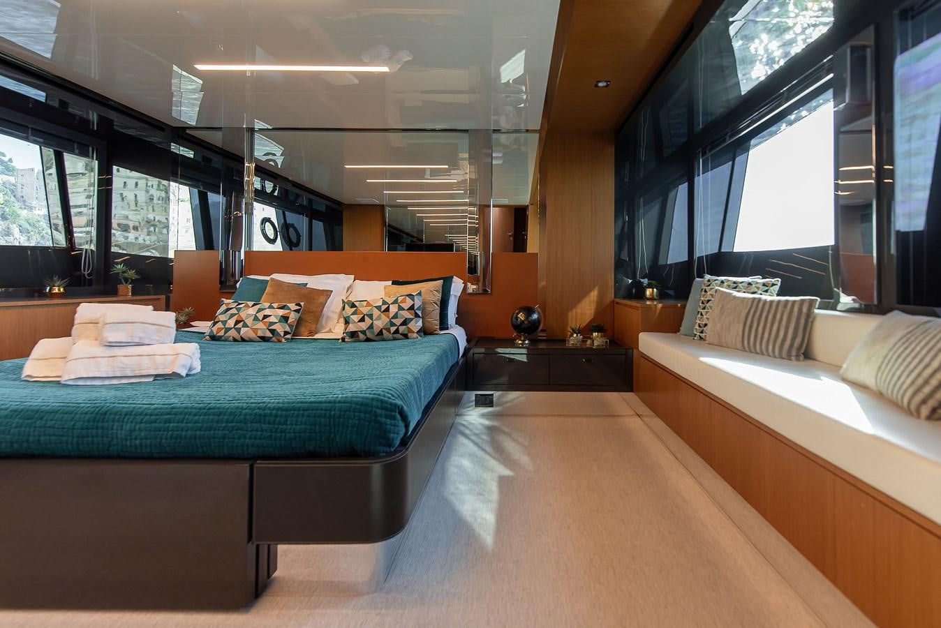 a room with a bed and a couch aboard SOUL Yacht for Sale