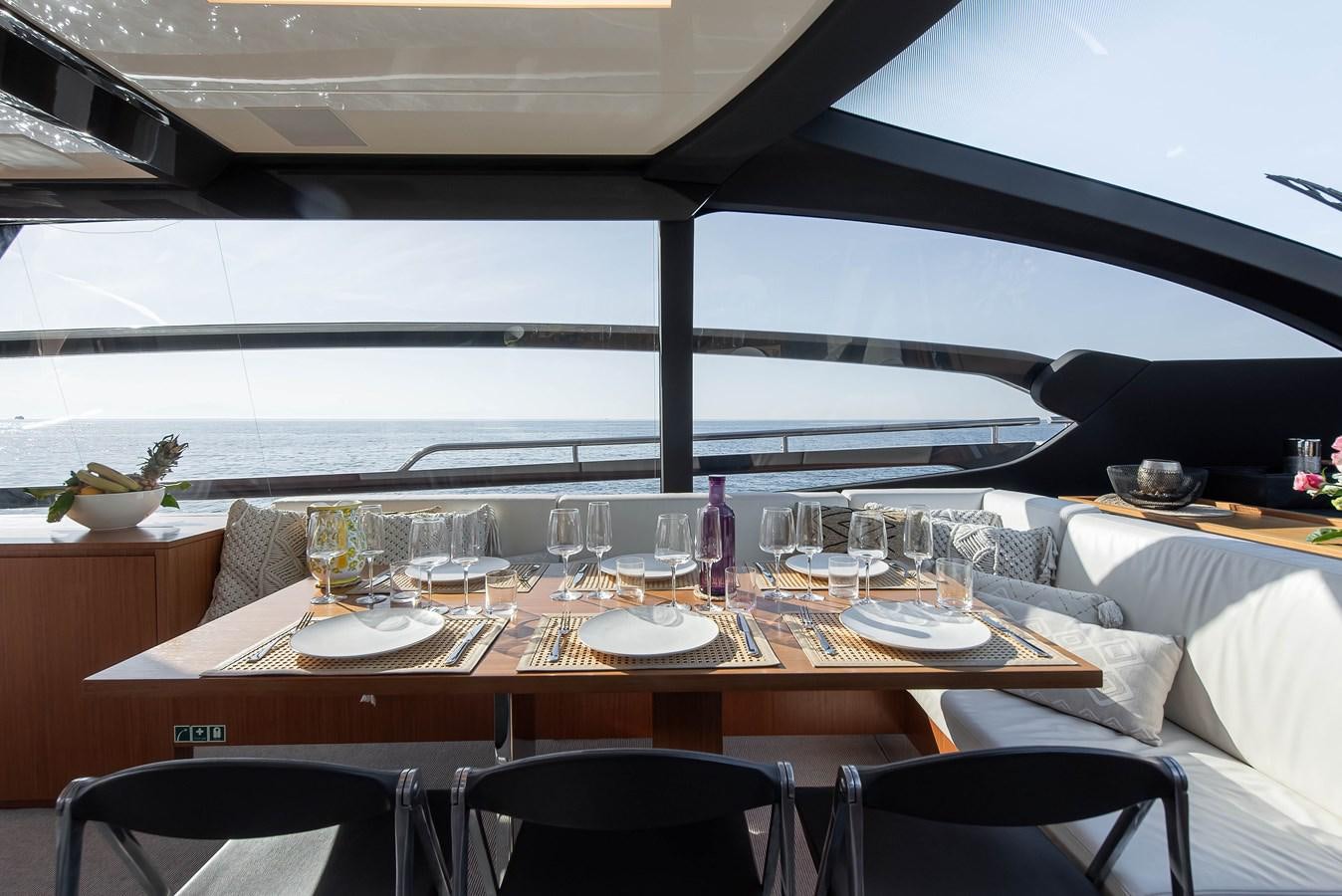 a table with wine glasses on it aboard SOUL Yacht for Sale